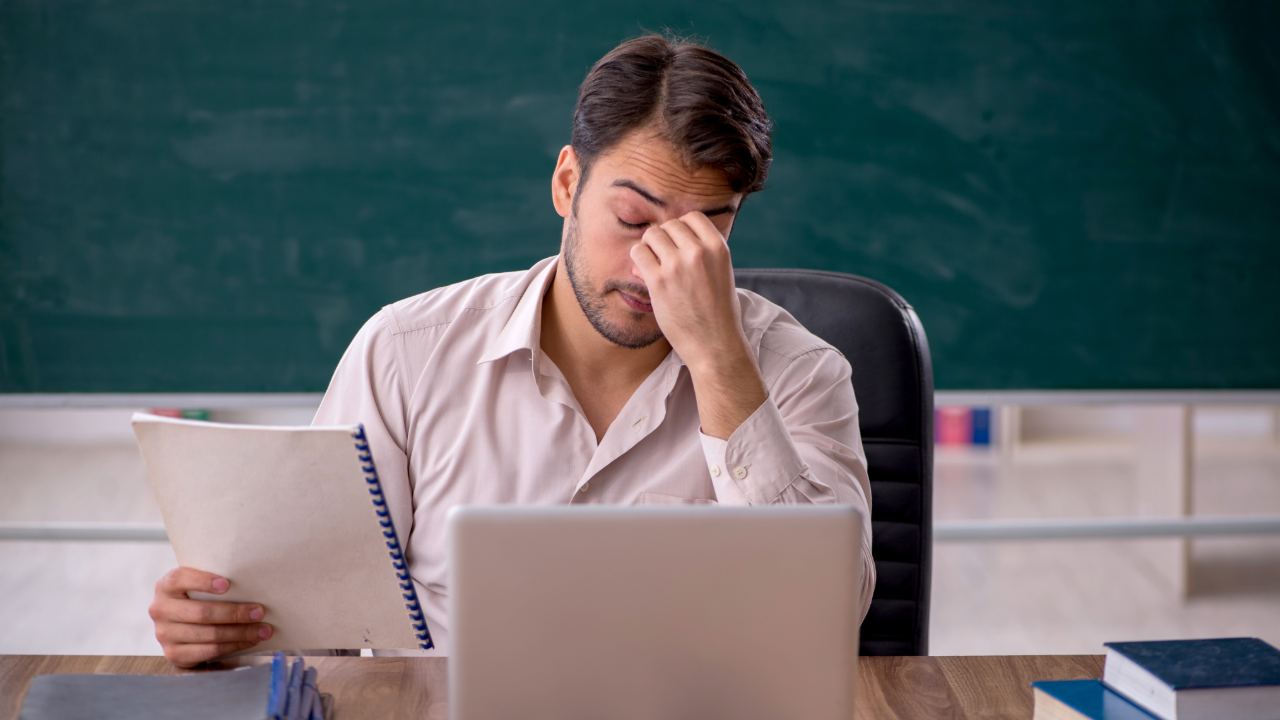 Burned Out Teacher at Desk